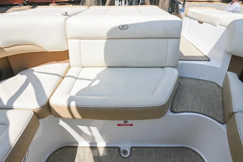 Slide: The Image of 2015 Cobalt 220 boat interior with beige cushioned seating and textured flooring. - 16