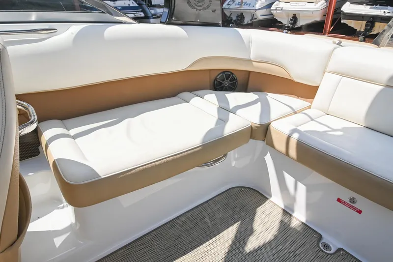 Slide: The Image of 2015 Cobalt 220 boat interior with beige and white seating. - 17