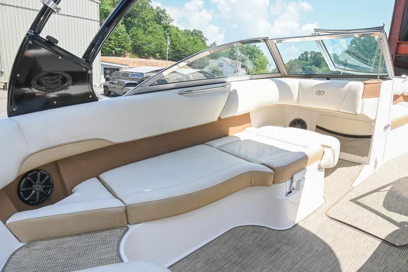 Slide: The Image of Interior of a 2015 Cobalt 220 boat with white and tan seating. - 18