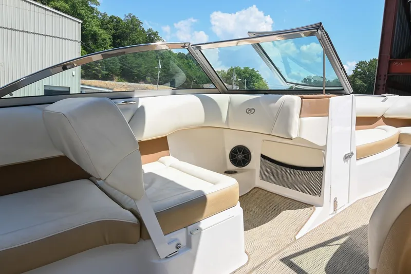Slide: The Image of Interior of a 2015 Cobalt 220 boat with beige and white seating. - 21