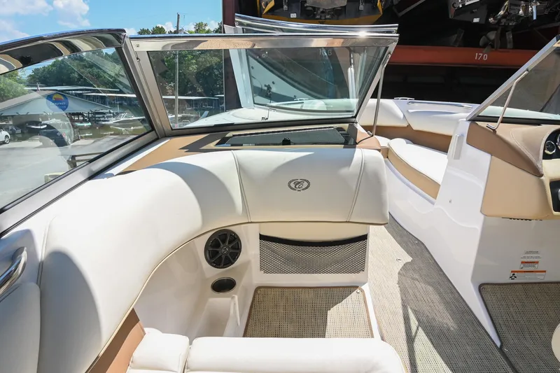 Slide: The Image of Interior of a 2015 Cobalt 220 boat with beige and white seating. - 22