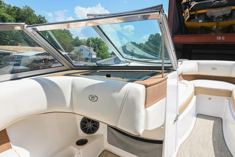 Slide: The Image of Interior of a 2015 Cobalt 220 boat with white and tan seating. - 23