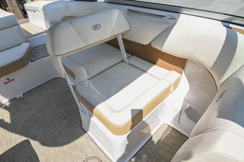 Slide: The Image of 2015 Cobalt 220 boat interior with beige and white seating. - 24