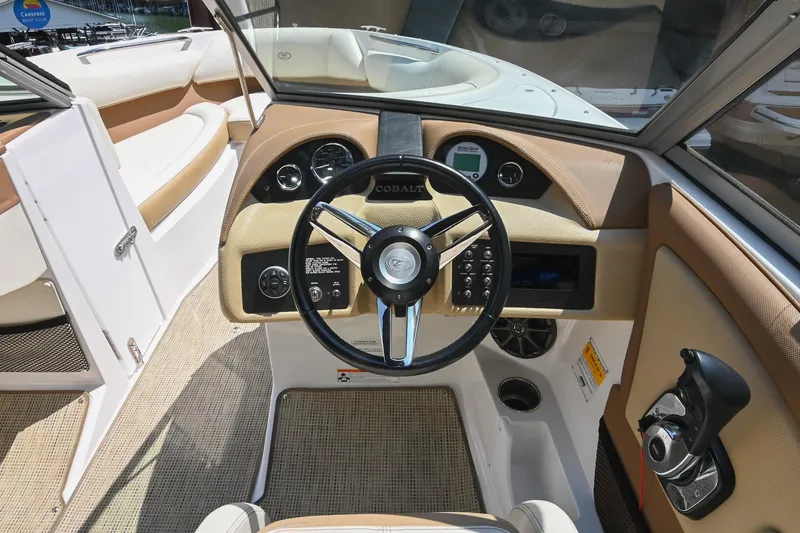 Slide: The Image of 2015 Cobalt 220 boat interior with steering wheel and dashboard controls. - 27