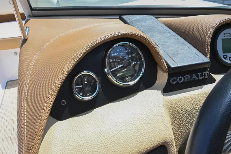Slide: The Image of Dashboard of a 2015 Cobalt 220 boat with speedometer and fuel gauge. - 28
