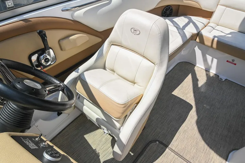Slide: The Image of Interior of a 2015 Cobalt 220 boat with beige and white seating. - 30