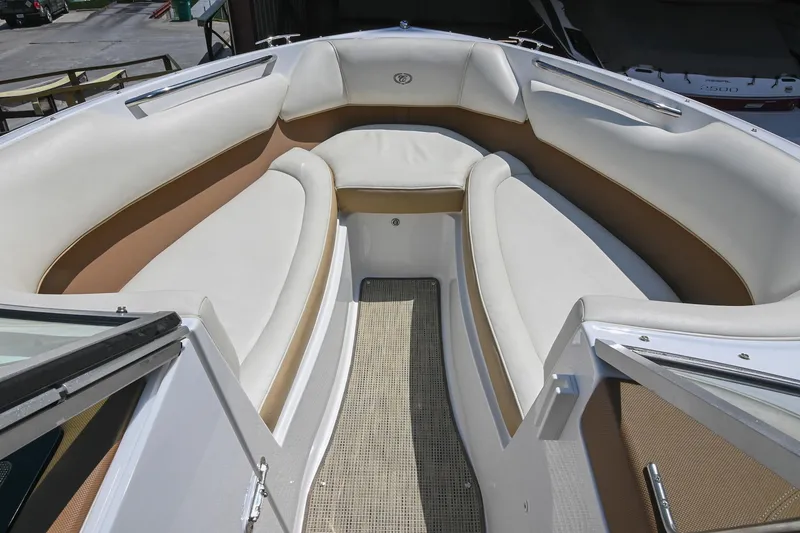 Slide: The Image of 2015 Cobalt 220 boat interior with white and tan seating, open bow design. - 32