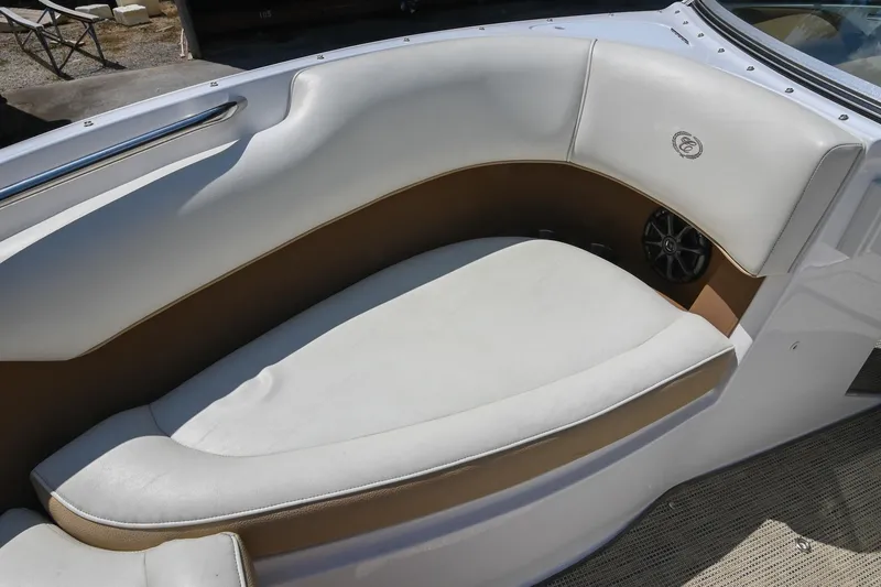 Slide: The Image of 2015 Cobalt 220 boat interior with white and tan seating, featuring a speaker. - 36