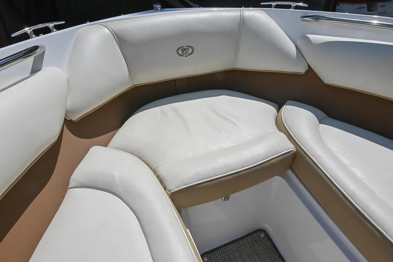 Slide: The Image of Luxurious seating in a 2015 Cobalt 220 boat, featuring white and tan upholstery. - 37