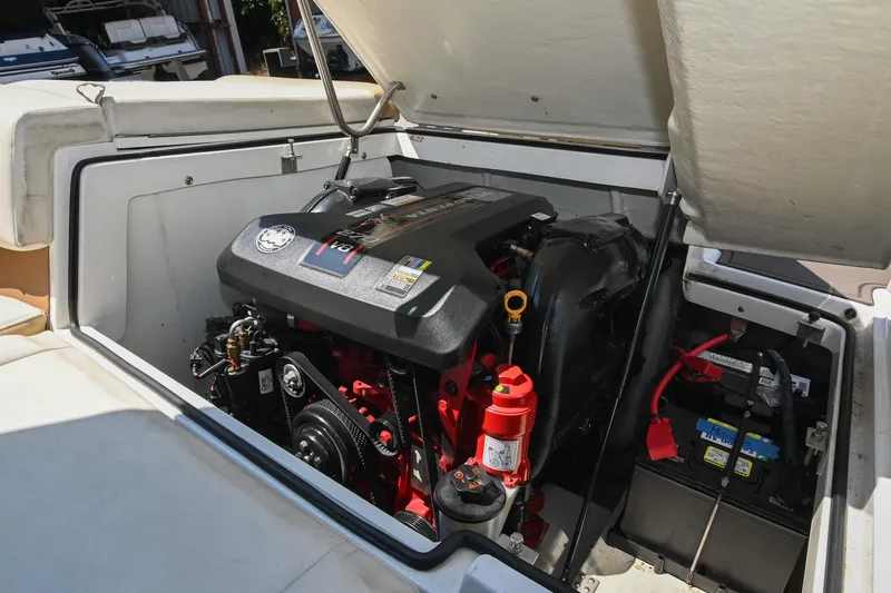 Slide: The Image of Engine compartment of a 2015 Cobalt 220 boat, showcasing the engine and battery setup. - 38