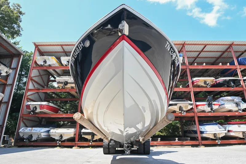 Slide: The Image of 2015 Cobalt 220 boat stored in a multi-level marina rack under a clear blue sky. - 6