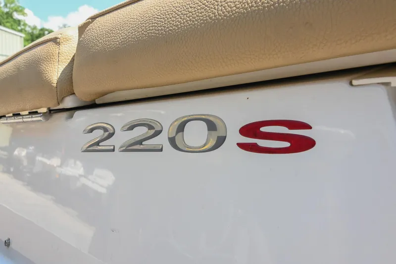 Slide: The Image of 2015 Cobalt 220S boat emblem with beige upholstery in sunlight. - 8