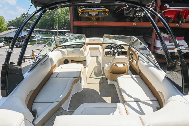Slide: The Image of 2015 Cobalt 220 boat interior with beige seating and sleek design. - 9