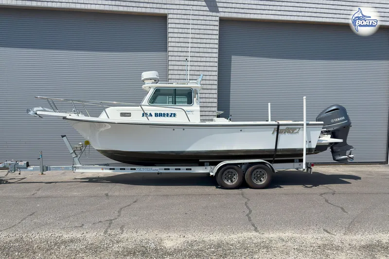 Slide: The Image of 2019 Parker 2320 Sport Cabin boat on trailer, side view, with Yamaha outboard motor. - 30
