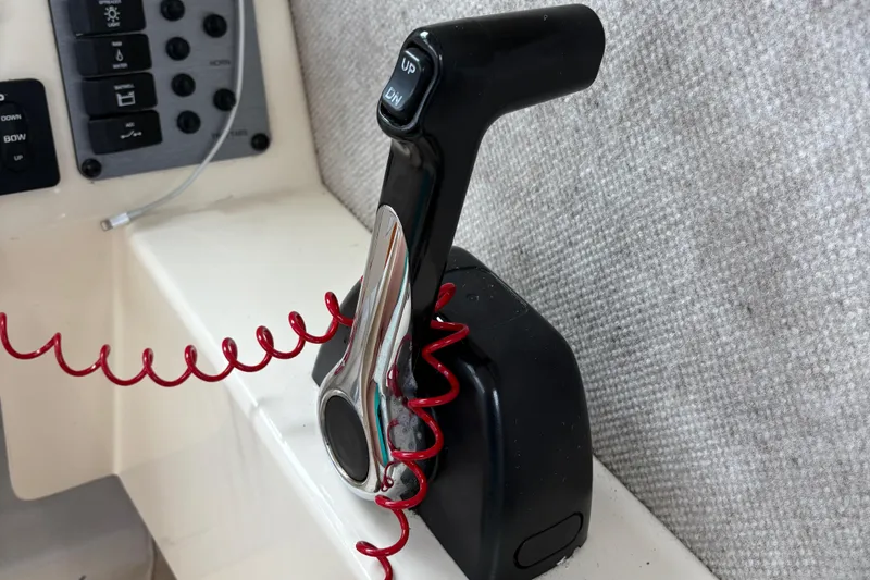 Slide: The Image of Throttle control lever in a 2012 Parker 2120 Sport Cabin boat cockpit. - 10