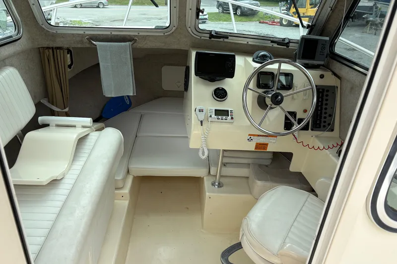 Slide: The Image of 2012 Parker 2120 Sport Cabin interior with steering wheel and seating. - 14