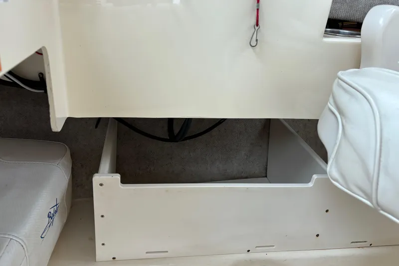 Slide: The Image of Interior view of a 2012 Parker 2120 Sport Cabin boat, featuring storage compartment. - 20