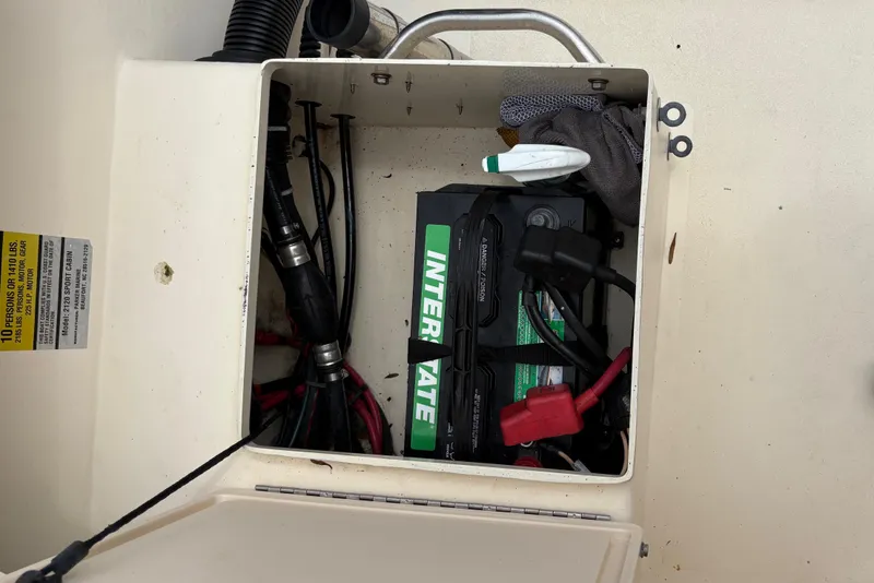 Slide: The Image of Battery compartment of a 2012 Parker 2120 Sport Cabin boat, showing wiring and components. - 26