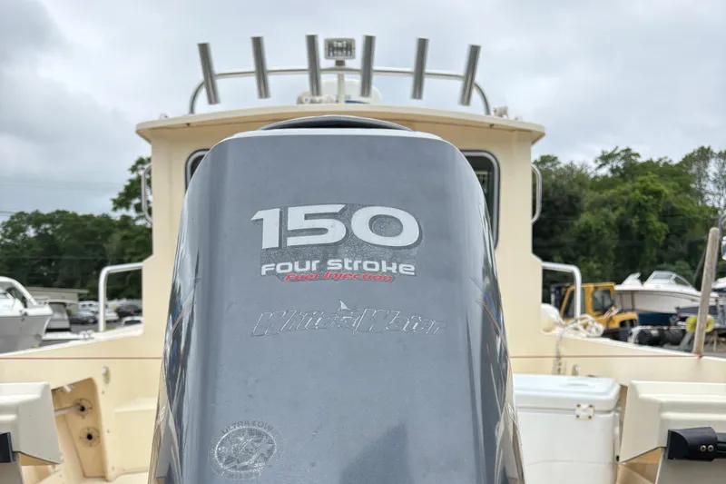 Slide: The Image of Outboard motor on 2012 Parker 2120 Sport Cabin boat, featuring 150 four-stroke engine. - 28