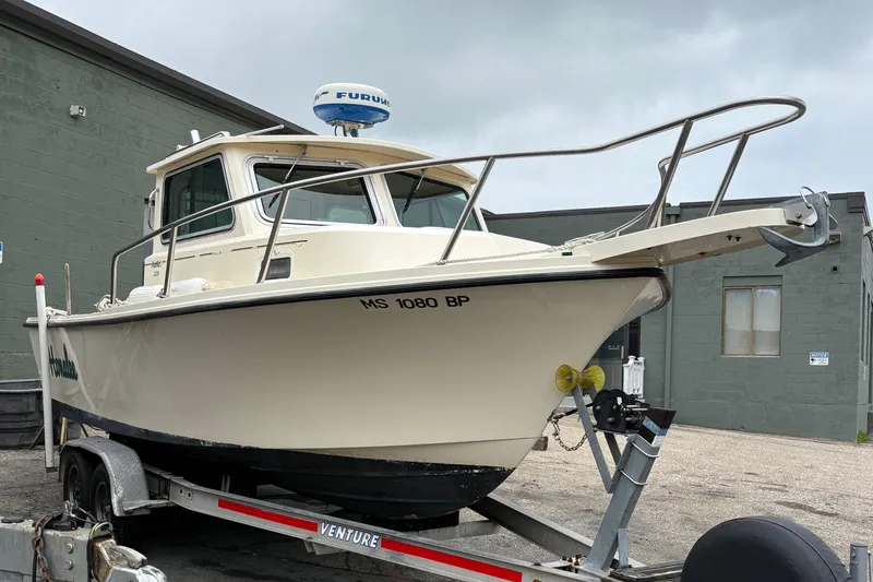 Slide: The Image of 2012 Parker 2120 Sport Cabin boat on trailer, parked outdoors. - 4