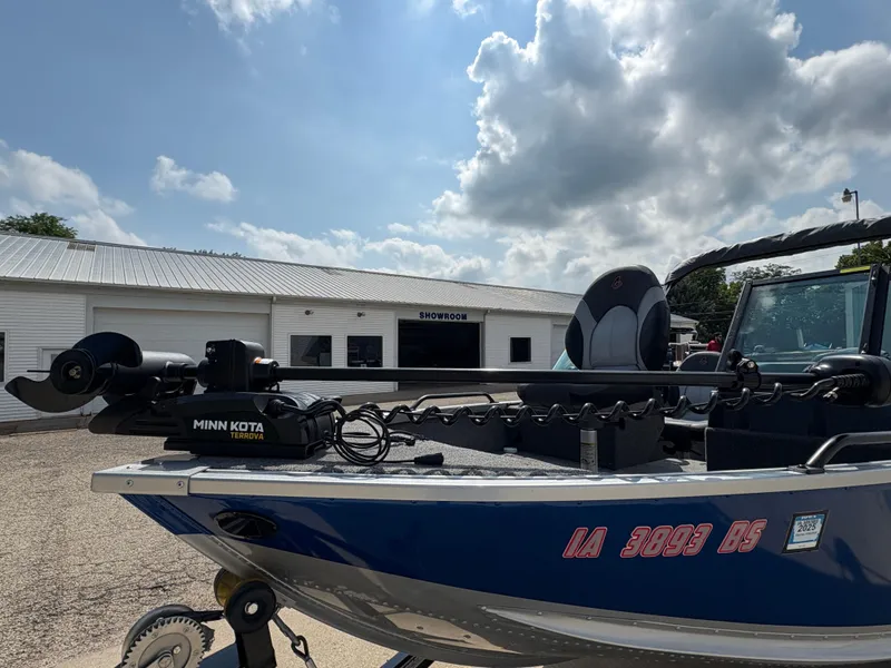 Slide: The Image of 2018 Alumacraft Voyageur 175 Sport boat with Minn Kota Terrova motor, parked outside showroom. - 10