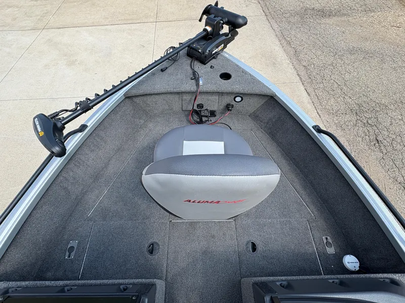 Slide: The Image of 2018 Alumacraft Voyageur 175 Sport boat interior with trolling motor and seating. - 12