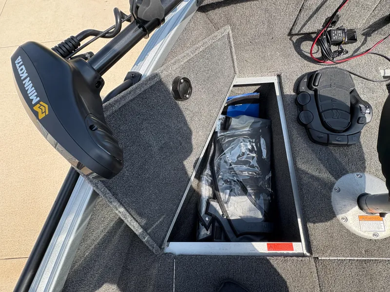 Slide: The Image of 2018 Alumacraft Voyageur 175 Sport boat interior with Minn Kota trolling motor and storage compartment. - 14