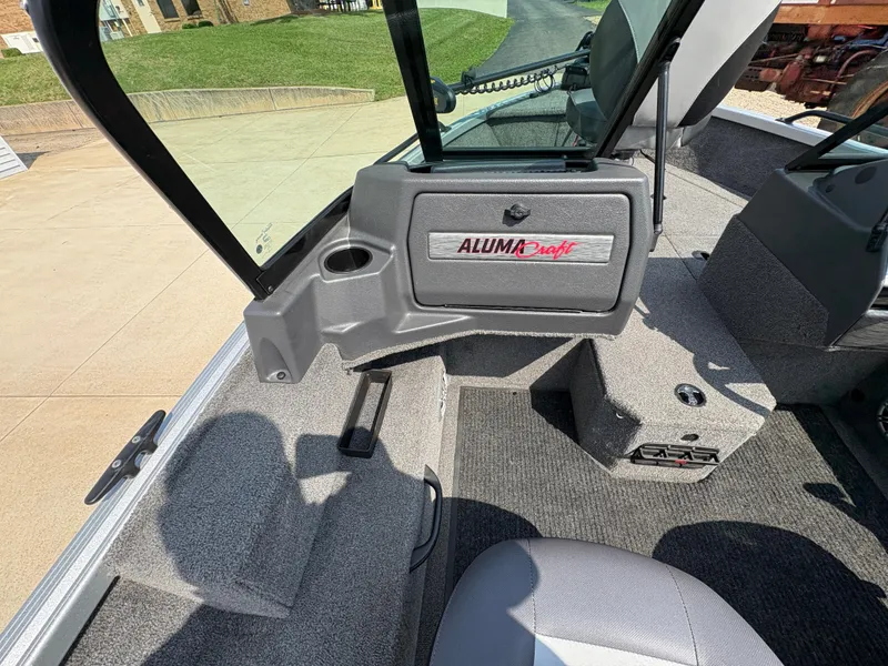 Slide: The Image of 2018 Alumacraft Voyageur 175 Sport boat interior with seating and storage compartments. - 21