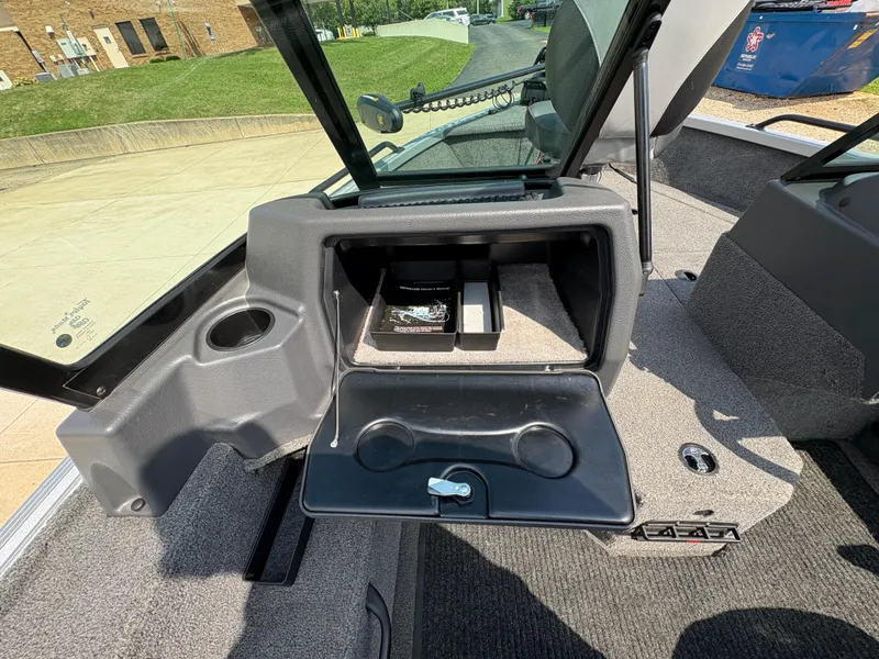Slide: The Image of 2018 Alumacraft Voyageur 175 Sport boat interior with open storage compartment. - 22