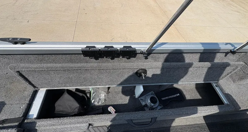 Slide: The Image of 2018 Alumacraft Voyageur 175 Sport boat storage compartment with accessories and equipment. - 25