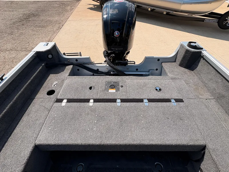 Slide: The Image of 2018 Alumacraft Voyageur 175 Sport boat interior with motor, showcasing spacious deck design. - 28