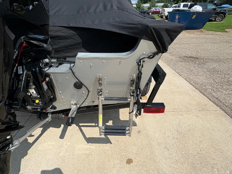 Slide: The Image of 2018 Alumacraft Voyageur 175 Sport boat with ladder and covered engine. - 33