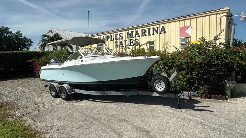 The Image of 2012 Sea Hunt Escape 220 LE boat on trailer at marina sales lot. - 0