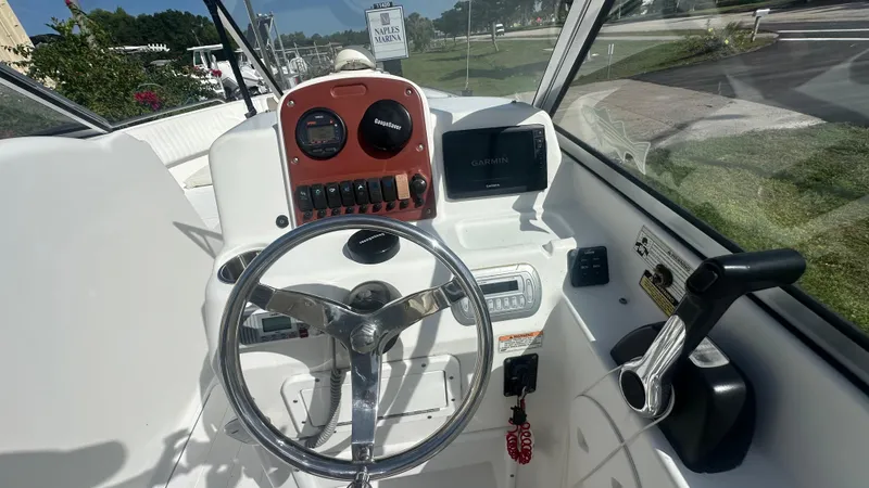 Slide: The Image of 2012 Sea Hunt Escape 220 LE boat dashboard with steering wheel and Garmin display. - 3