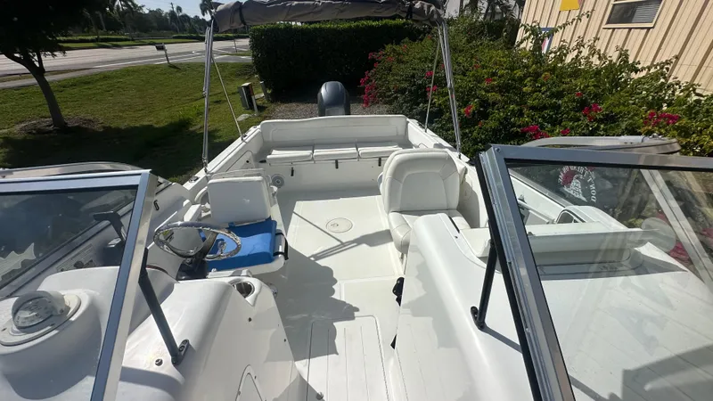 Slide: The Image of 2012 Sea Hunt Escape 220 LE boat interior with seating and steering wheel. - 4