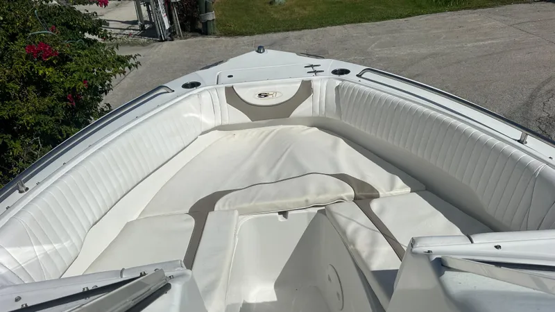 Slide: The Image of 2012 Sea Hunt Escape 220 LE boat with white cushioned seating in the bow area. - 5