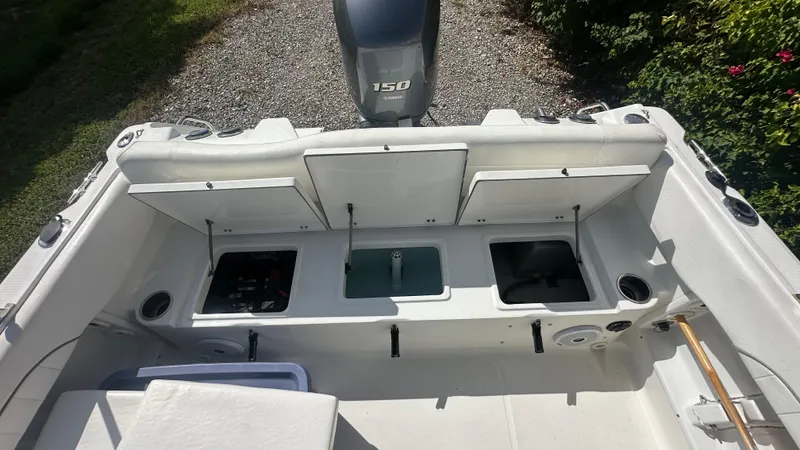 Slide: The Image of 2012 Sea Hunt Escape 220 LE boat interior with storage compartments and outboard motor. - 6