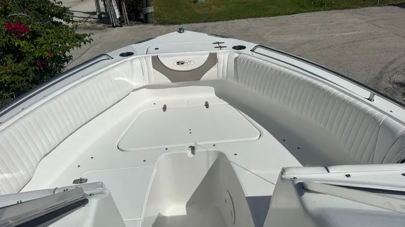 Slide: The Image of 2012 Sea Hunt Escape 220 LE boat interior with white seating and open deck. - 8