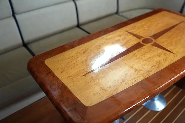Slide: The Image of Polished wooden table with compass design in 2006 Sabre 38 Hardtop Express interior. - 10