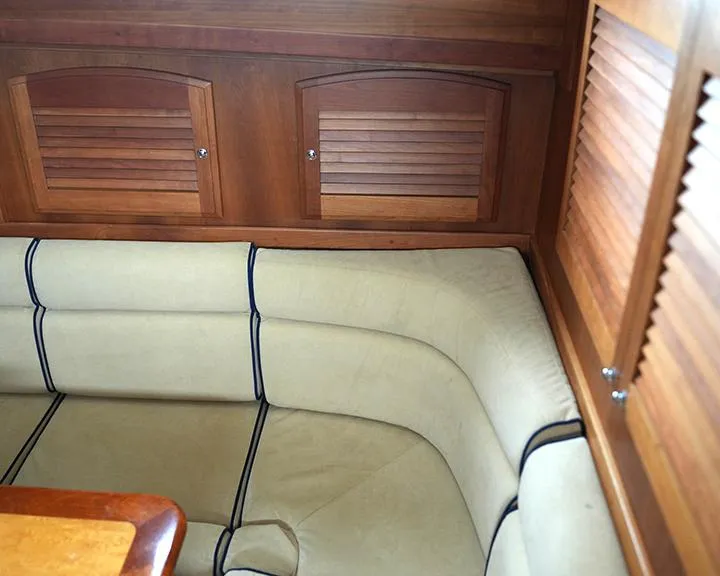 Slide: The Image of 2006 Sabre 38 Hardtop Express interior with beige seating and wooden cabinetry. - 13