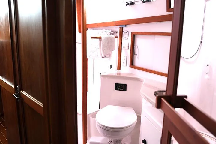 Slide: The Image of 2006 Sabre 38 Hardtop Express bathroom with wooden accents and modern fixtures. - 14
