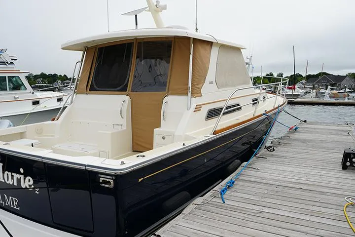 Slide: The Image of 2006 Sabre 38 Hardtop Express docked at a marina, featuring a sleek design. - 2