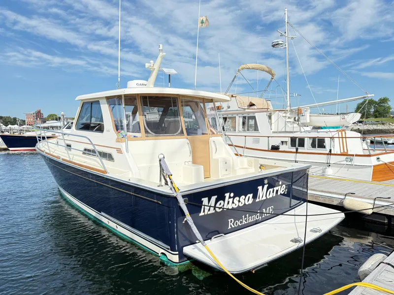 Slide: The Image of 2006 Sabre 38 Hardtop Express boat docked at marina under blue sky. - 3