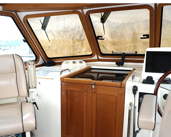 Slide: The Image of Interior of 2006 Sabre 38 Hardtop Express boat with helm and seating area. - 4