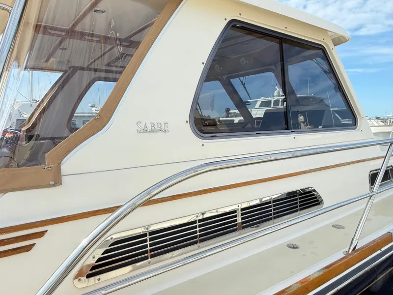Slide: The Image of 2006 Sabre 38 Hardtop Express yacht with sleek design and polished metal accents. - 6