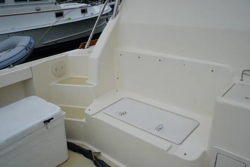 Slide: The Image of 2006 Sabre 38 Hardtop Express boat interior with seating and storage compartments. - 7
