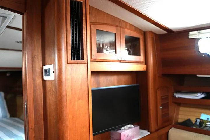 Slide: The Image of Interior of 2006 Sabre 38 Hardtop Express with wood paneling and mounted TV. - 9