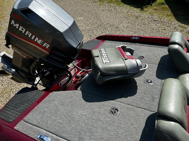 Slide: The Image of 1999 Triton 180 boat with Mariner engine, gray seating, and carpeted deck. - 10