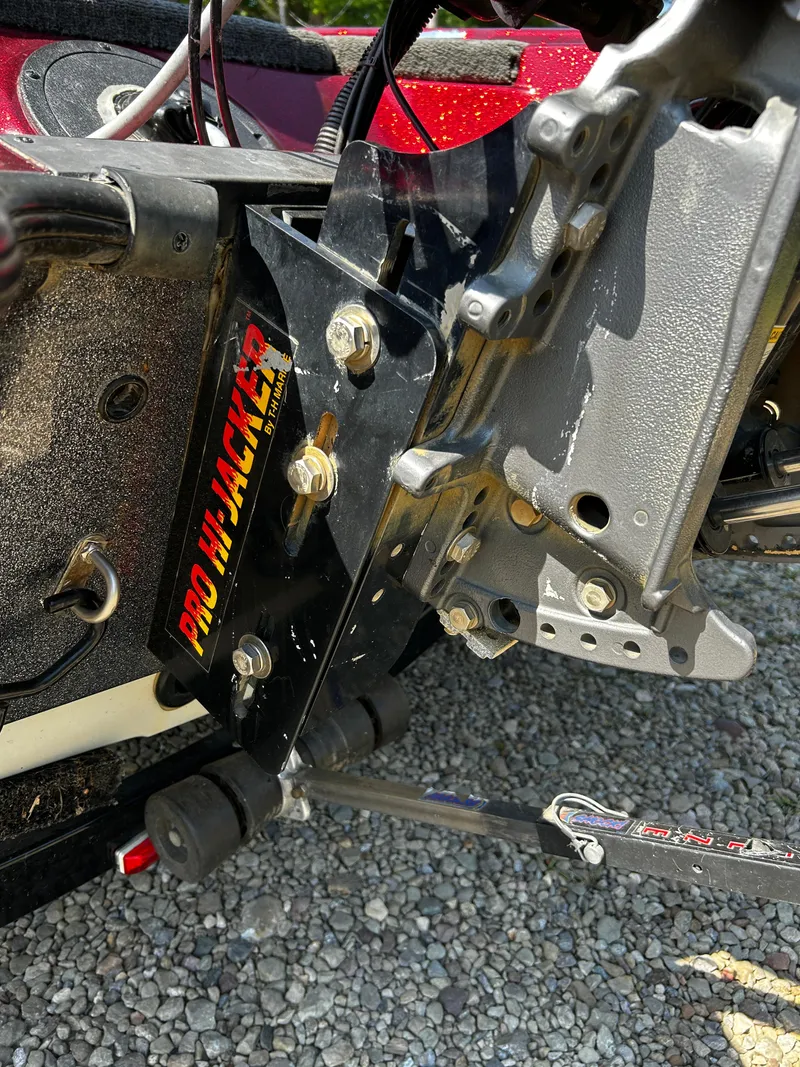 Slide: The Image of Close-up of a 1999 Triton 180 boat's Pro Hi-Jacker jack plate on gravel. - 4