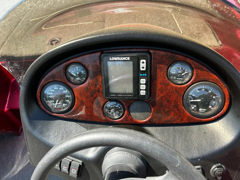 Slide: The Image of Dashboard of a 1999 Triton 180 boat with gauges and Lowrance X48 display. - 7